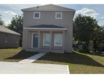 Inviting new construction home featuring a covered front porch, concrete driveway and a well manicured front lawn at 4189 Radford Rd, Bartow, FL 33830