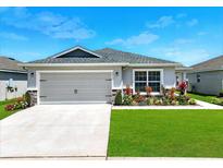 Charming single-story home with a well-maintained lawn and a two-car garage at 4412 Reding Way, Lakeland, FL 33813
