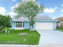 Charming one-story home featuring a spacious front yard and an attached two-car garage at 537 Eagle Run, Lakeland, FL 33809