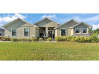 Charming single story home with a well-manicured lawn and landscaped flower beds at 6372 English Creek Dr, Lakeland, FL 33811