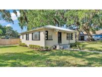 Charming single-story home featuring a well-manicured lawn and mature trees providing ample shade at 747 E Bella Vista St, Lakeland, FL 33805