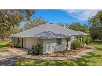Charming single-story home featuring lush landscaping, a two-car garage, and a well-maintained lawn at 12301 Jim Edwards Rd, Haines City, FL 33844