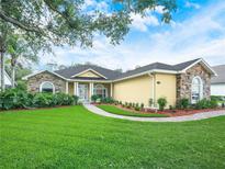 Charming single-story home with stone accents and a beautifully landscaped front yard at 3300 Hawks Ridge Dr, Lakeland, FL 33810
