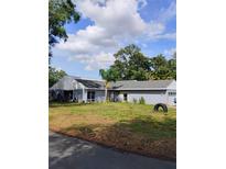 Spacious single-story home with a manicured lawn and mature trees at 4734 Valley Hill Ct, Lakeland, FL 33813