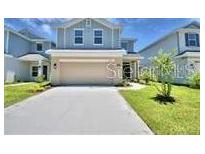 Charming home showcasing a well-manicured lawn and a two-car garage at 2307 Brassie Ct, Winter Haven, FL 33884