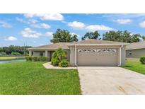 Charming single-story home with well-maintained landscaping and attached two car garage at 2764 Oak Hammock Loop, Mulberry, FL 33860