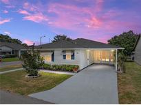 Charming single-story home featuring a covered carport and well-maintained landscaping at 4965 Goldenview Ln, Lakeland, FL 33811