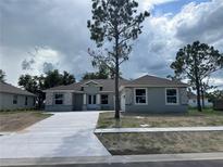 Beautiful new home boasting stone accents, neutral paint and a long concrete driveway at 505 Shanklin Ave, Bartow, FL 33830