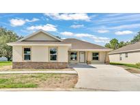 Charming single-story home with a light exterior, stone accents, and a spacious driveway at 803 Allison Place, Bartow, FL 33830