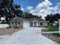 Charming single-story home with a two-car garage, stone accents and well-manicured landscaping at 803 Allison Place, Bartow, FL 33830
