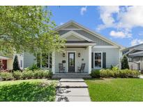 Charming single-story home with inviting front porch and landscaped garden at 117 Palmola St, Lakeland, FL 33803