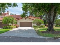 Charming home exterior featuring a well-maintained lawn and a two-car garage with lush, mature trees at 139 Stratford Ct, Haines City, FL 33844
