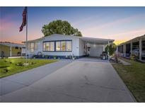 Charming single-story home featuring a covered carport, well-maintained lawn, and tasteful landscaping at 1506 Longbow Dr, Lakeland, FL 33810