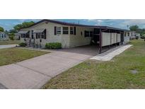 Charming single-story home with a carport and well-maintained landscaping at 1823 Sherwood Hill Dr, Lakeland, FL 33810
