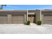 Townhouse front entrance featuring a private door and single-car garage at 2500 21St Nw St # 78, Winter Haven, FL 33881