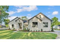 Beautiful exterior of a home featuring a manicured lawn and a stone facade, creating a welcoming curb appeal at 5087 Cliffside Drive, Lakeland, FL 33813