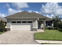 Charming home with a brick driveway, stone accents and well-maintained landscaping at 7779 Lake James Blvd, Lakeland, FL 33810