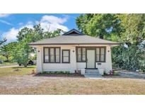Charming single-story home featuring a gray roof and a welcoming front entry framed with new landscaping at 919 S Missouri Ave, Lakeland, FL 33803