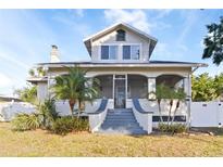 Charming home featuring a large, screened-in front porch and well-manicured landscaping at 934 Lake Elbert Se Dr, Winter Haven, FL 33880