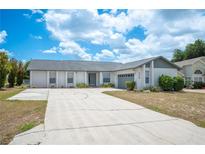 Lovely single-story home with a spacious driveway, well-kept lawn, and beautiful landscaping at 3226 Cherry Hill S Cir, Lakeland, FL 33810