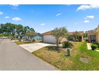 Charming home featuring a two-car garage and neatly landscaped front yard at 4428 Glenns Lndg, Winter Haven, FL 33884