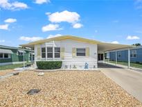 Charming single-story home with a covered carport and a beautiful, low-maintenance rock garden at 5027 Forest Crest Dr, Lakeland, FL 33810