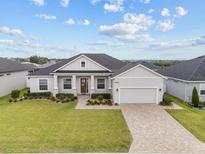 Charming single-story home with manicured lawn, stone accents, and a paved driveway at 6627 Ridgemont Rd, Lakeland, FL 33813