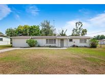 Charming single-story home with a well-maintained lawn and attached garage at 2520 Avenue C Sw, Winter Haven, FL 33880