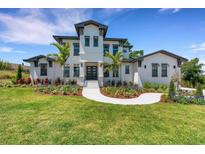 Beautiful two-story home with manicured lawn and garden at 2645 Delphi Hills Ct, Lakeland, FL 33812