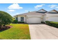 Charming single-story home with a well-maintained lawn and a two-car garage at 2820 Prestwick Dr, Lakeland, FL 33803
