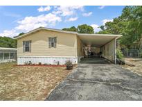 Charming single story home boasting a covered carport and an airy, spacious front yard at 36912 Skycrest Blvd, Fruitland Park, FL 34731