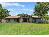 Inviting single-story home featuring a large front yard, complemented by a unique architectural design with plentiful windows at 3805 Gaines Dr, Winter Haven, FL 33884