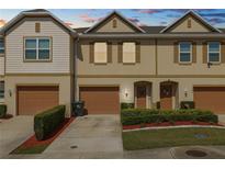 Charming townhome with a well-maintained lawn, a one-car garage, and a welcoming entrance at 3857 Hampstead Ln, Lakeland, FL 33810
