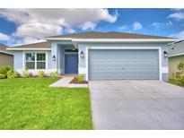 Charming single-story home featuring a well-manicured lawn and a two-car garage at 539 Tanaro Ln, Haines City, FL 33844