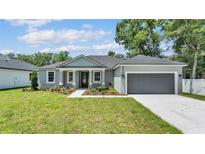 Charming single-story home features a manicured lawn and a welcoming front entrance with decorative columns at 5512 Odom Rd, Lakeland, FL 33809