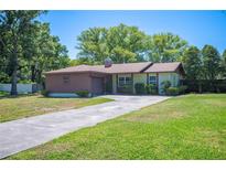 Charming single-story home with a well-manicured lawn and long driveway at 6529 Farris Dr, Lakeland, FL 33811