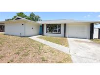 Charming home featuring a bright blue front door and a well-maintained front yard at 108 Sandburg Ln, Winter Haven, FL 33884