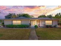 Charming home featuring stone accents, a well-manicured lawn, and a welcoming front entrance at 1195 E George St, Bartow, FL 33830