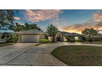 Charming single-story home featuring a well-manicured lawn and a circular driveway at 1854 Sherwood Lakes Blvd, Lakeland, FL 33809