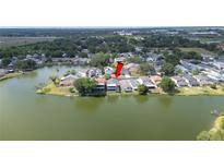 Stunning aerial view of a lakeside home with lush landscaping and tranquil water views at 2015 Hatteras Pt, Lakeland, FL 33813