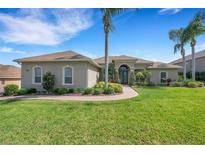 Charming single-story home featuring lush landscaping, a circular driveway, and a welcoming front entrance at 2743 Verandah Vue Way, Lakeland, FL 33812