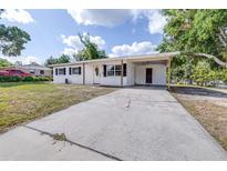 Charming single-story home with a spacious driveway, covered carport, and a well-maintained front yard at 280 W Pierce St, Lake Alfred, FL 33850
