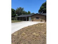 Charming single-story home featuring a covered front porch and long driveway at 4127 Grove Pl, Lakeland, FL 33810