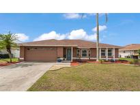 Charming single-story home boasts a well-manicured lawn, mature landscaping, and inviting curb appeal at 5246 Montserrat Dr, Lakeland, FL 33812