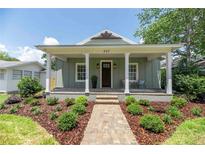 Charming single-story home with a welcoming front porch and well-manicured landscaping at 527 W Park St, Lakeland, FL 33803