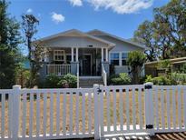 Charming single Gathering home featuring a well maintained yard, picket fence, and a covered front porch at 807 Osceola St, Lakeland, FL 33801