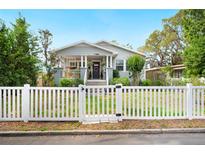 Charming home featuring a white picket fence and a welcoming front porch at 807 Osceola St, Lakeland, FL 33801