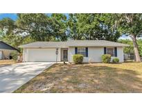 Charming single-story home with a well-maintained lawn and attached two-car garage at 819 Swann Dr, Lakeland, FL 33809