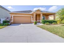 Charming single-story home with a two-car garage, well-maintained lawn, and inviting curb appeal at 983 Revere Ave, Haines City, FL 33844