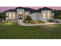 Beautiful single-story home with a well-manicured lawn and inviting landscaped entrance at 130 Sylvana Ct, Auburndale, FL 33823